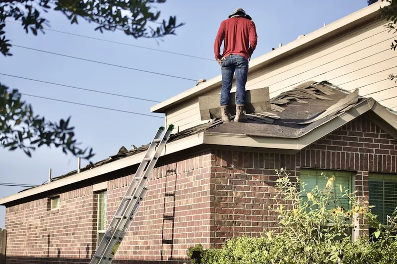 Professional roofer working on a residential roof in Santa Fe Springs